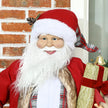 Santa figure displayed beside a Christmas tree