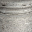 Close-up of the weathered grey stone-effect base