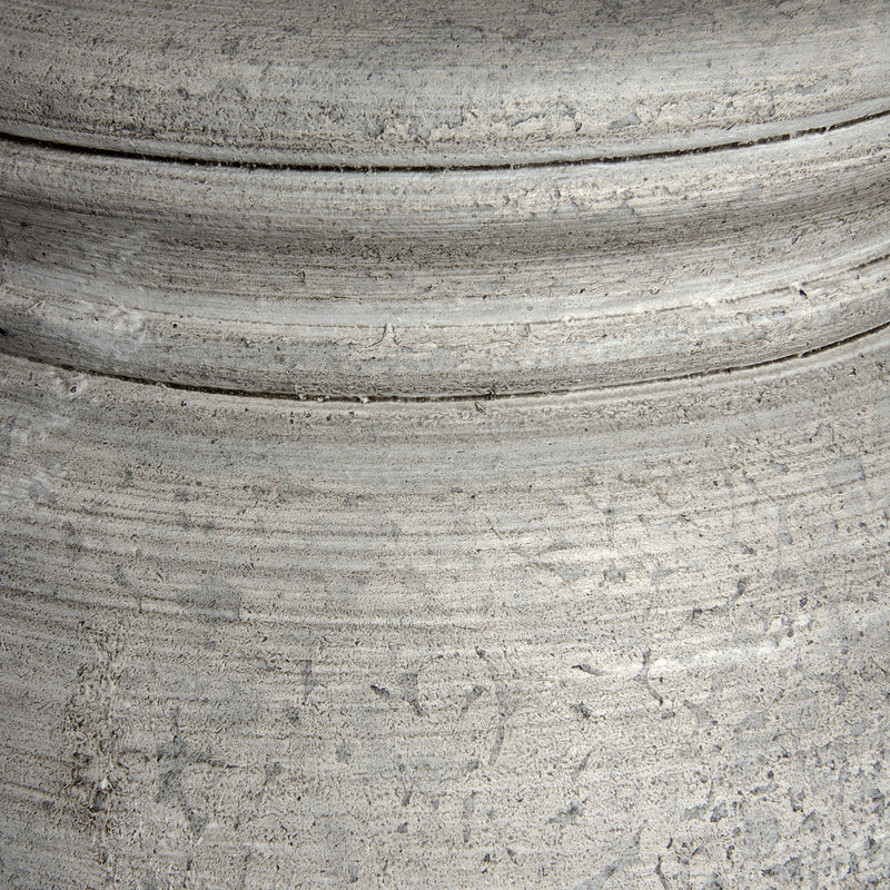 Close-up of the weathered grey stone-effect base