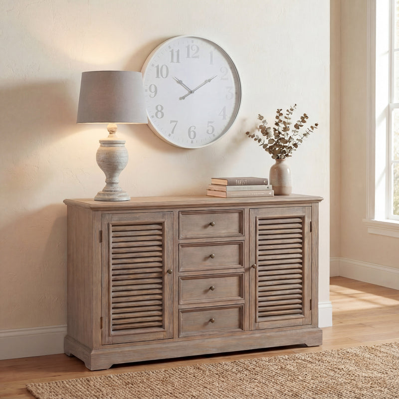 Uthina lamp on a louvred sideboard beneath a large wall clock