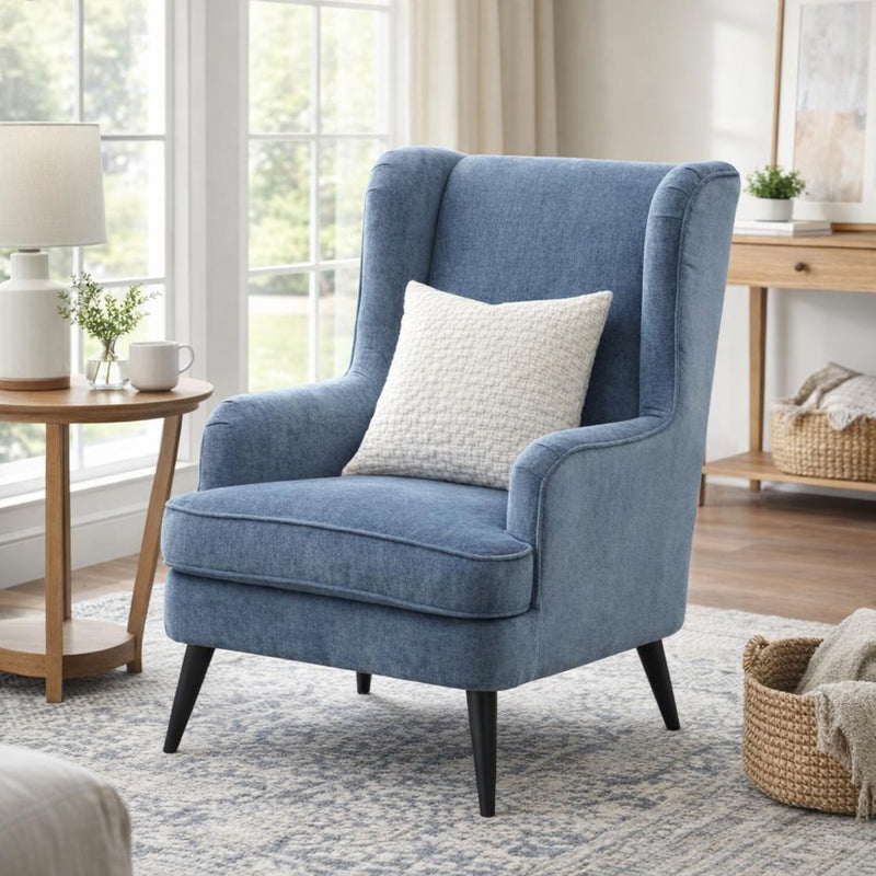 blue wingback armchair in a bright living room