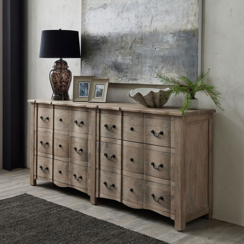 White washed photo frames styled on a sideboard in a living room