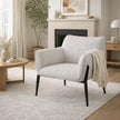 off-white armchair with a throw in a living room