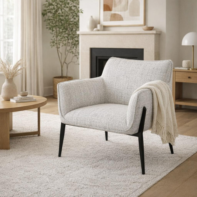 off-white armchair with a throw in a living room